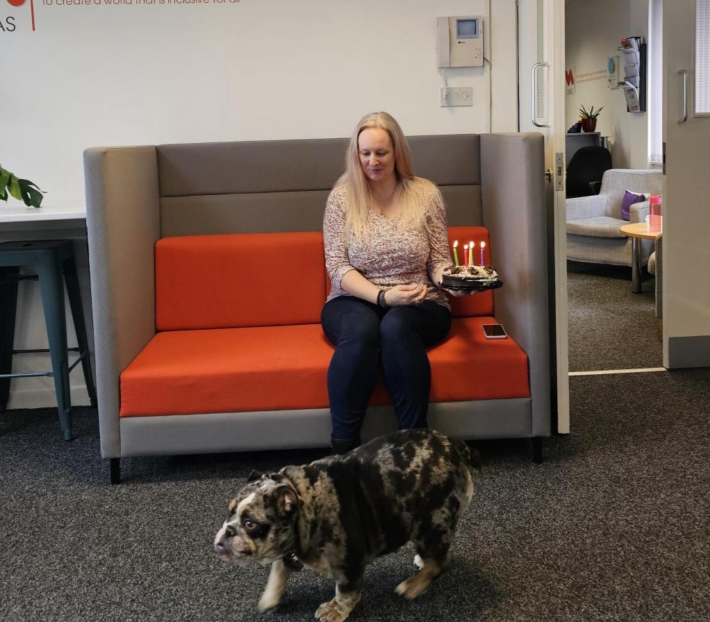 VIAS staff celebrating Deputy CEO Donna-Marie's birthday, gathered around a birthday cake.
